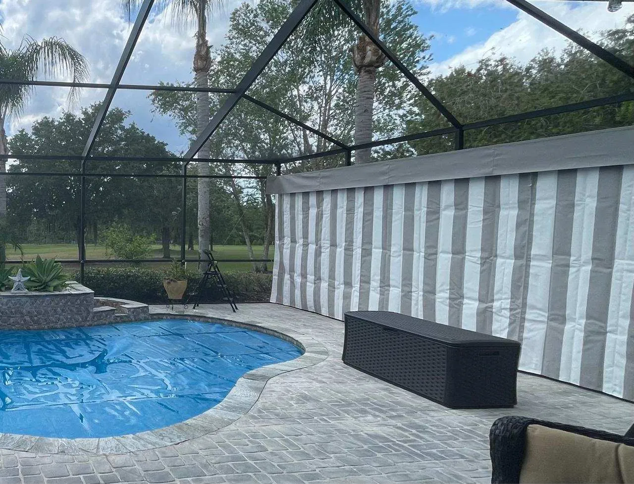 Striped Sunbrella lanai curtains fitted inside Southwest Florida pool enclosure